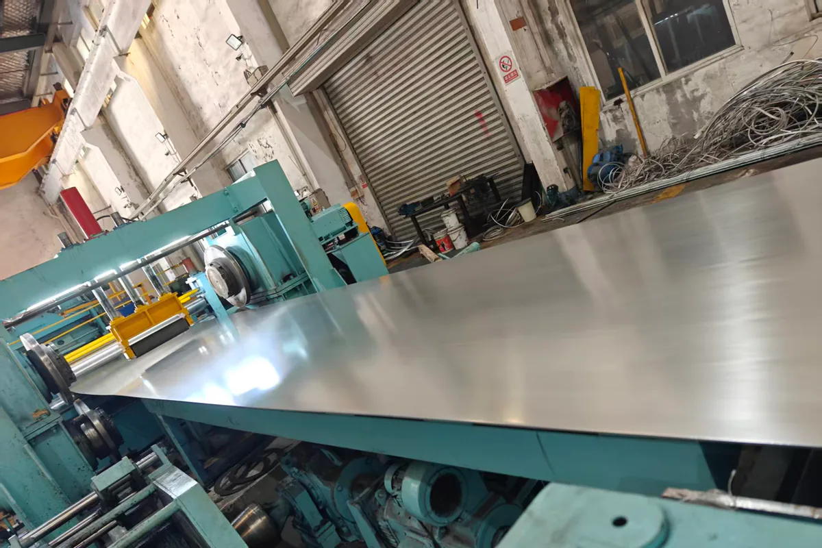 Stainless steel coil feeding a guarded levelling and cut-to-length line
