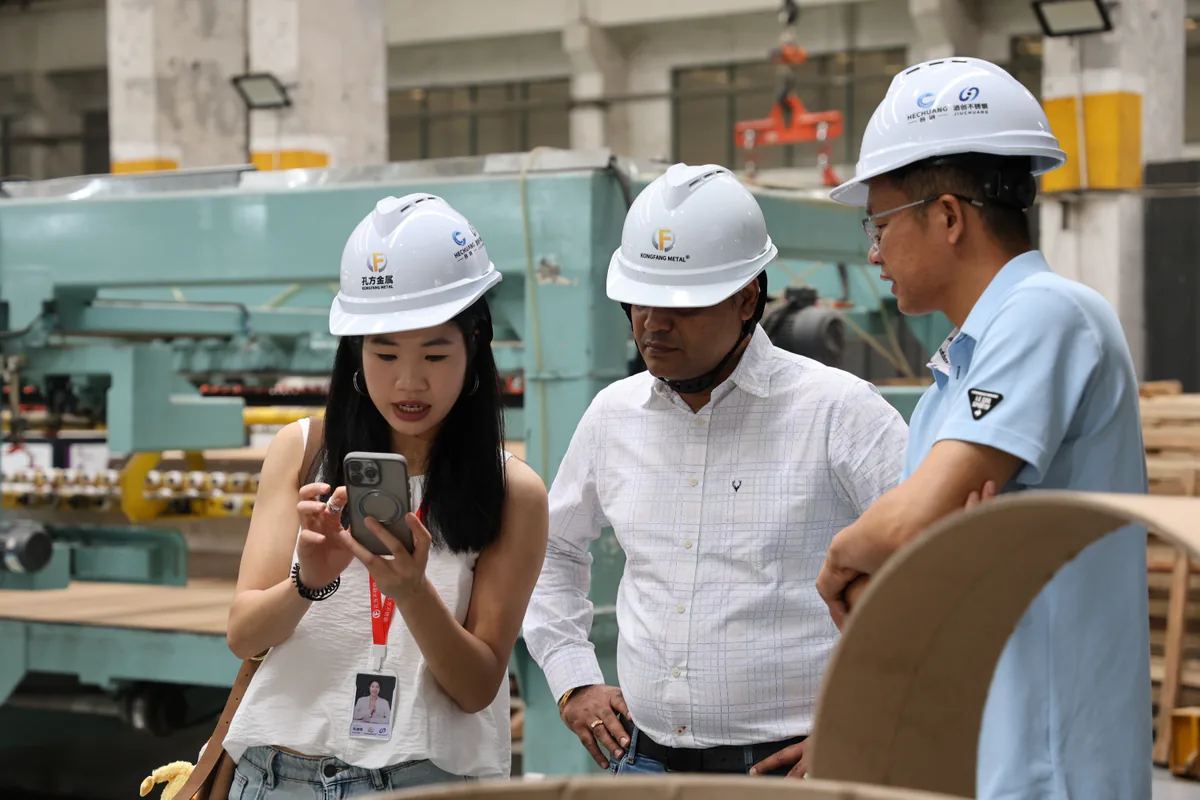 Hechuang team reviewing a stainless coil processing line